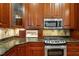 Custom kitchen featuring granite countertops, tiled backsplash, and a stainless steel oven range at 3509 Carlton Square Pl, Raleigh, NC 27612