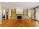 Spacious living room with hardwood floors, fireplace, built-in shelving, and elegant detailing at 3509 Carlton Square Pl, Raleigh, NC 27612