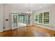 Elegant living room with hardwood floors, chandelier, and French doors leading to sunroom at 3509 Carlton Square Pl, Raleigh, NC 27612