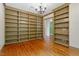 Spacious office with custom bookshelves, hardwood floors, and elegant lighting at 3509 Carlton Square Pl, Raleigh, NC 27612