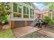 Brick patio with grill, lattice-covered foundation, sunroom and stairs to backyard at 3509 Carlton Square Pl, Raleigh, NC 27612