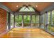 Bright sunroom with wood ceiling, brick accent wall and an abundance of natural light at 3509 Carlton Square Pl, Raleigh, NC 27612