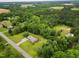 Picturesque aerial perspective of a residence with a long driveway, healthy lawn, and a backdrop of dense trees at 3906 Union Ridge Rd, Burlington, NC 27217