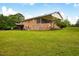 Expansive backyard featuring a brick home with a screened-in porch and covered patio, perfect for outdoor living at 3906 Union Ridge Rd, Burlington, NC 27217