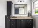 Bathroom featuring dark cabinets, a granite countertop, and a large, framed mirror at 3906 Union Ridge Rd, Burlington, NC 27217