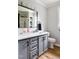 Elegant bathroom featuring a gray vanity with black hardware, quartz countertop, and a framed mirror at 3906 Union Ridge Rd, Burlington, NC 27217
