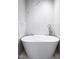 Modern bathroom featuring a standalone bathtub and white marble-style tiles at 3906 Union Ridge Rd, Burlington, NC 27217