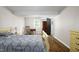 Bedroom with hardwood floors, natural light from the window and decorative vintage furniture pieces at 3906 Union Ridge Rd, Burlington, NC 27217