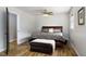 Bedroom featuring wood-look flooring and a comfortable bed with a decorative pillow at 3906 Union Ridge Rd, Burlington, NC 27217