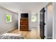 Bedroom with a TV, dresser, hardwood-style floors, and easy access to another room at 3906 Union Ridge Rd, Burlington, NC 27217