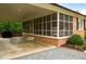 Cozy screened in porch with brick flooring and a spacious carport for outdoor entertaining at 3906 Union Ridge Rd, Burlington, NC 27217