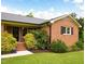 Brick home with black shutters, blooming bushes and a well-manicured lawn, offering charm and curb appeal at 3906 Union Ridge Rd, Burlington, NC 27217