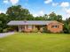 Charming brick home with a well-manicured lawn and covered carport perfect for enjoying the outdoors at 3906 Union Ridge Rd, Burlington, NC 27217