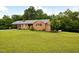 Well-maintained brick home with lush green lawn, mature landscaping, and a classic, inviting facade at 3906 Union Ridge Rd, Burlington, NC 27217
