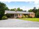 Charming brick home showcasing a screened-in carport, well-manicured lawn, and inviting curb appeal at 3906 Union Ridge Rd, Burlington, NC 27217