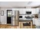 Well-lit kitchen boasts white cabinets, stainless steel appliances, and a convenient center island at 3906 Union Ridge Rd, Burlington, NC 27217