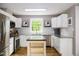Bright kitchen features white cabinets, stainless steel appliances, granite countertops, and center island at 3906 Union Ridge Rd, Burlington, NC 27217