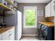 Functional laundry room with butcher block countertops, ample storage, and a view to the backyard at 3906 Union Ridge Rd, Burlington, NC 27217