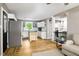 Open floor plan showcasing kitchen with island, living room, and stylish barn doors leading to laundry at 3906 Union Ridge Rd, Burlington, NC 27217