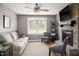 Inviting living room features a brick fireplace, plush seating, and ample natural light at 3906 Union Ridge Rd, Burlington, NC 27217