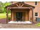 Covered patio with outdoor seating offers a cozy spot for relaxation and entertainment at 3906 Union Ridge Rd, Burlington, NC 27217