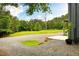 View of the expansive gravel driveway and surrounding wooded acreage at 3906 Union Ridge Rd, Burlington, NC 27217