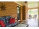 Inviting screened-in porch with brick walls, cozy seating, and plenty of natural light at 3906 Union Ridge Rd, Burlington, NC 27217
