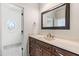 Charming bathroom with vanity, framed mirror, and natural light; doorway view to round window at 3908 Chaumont Dr, Apex, NC 27539