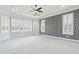 Main bedroom with tray ceilings, carpeted floors, and an abundance of natural light at 3908 Chaumont Dr, Apex, NC 27539