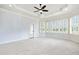 Bright bedroom boasts large windows, modern ceiling fan, plush carpet, and access to the outdoors at 3908 Chaumont Dr, Apex, NC 27539