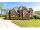 Beautiful two-story brick home featuring manicured landscaping and an attached three-car garage at 3908 Chaumont Dr, Apex, NC 27539