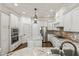 Modern kitchen featuring stainless steel appliances, granite countertops, and custom cabinetry at 3908 Chaumont Dr, Apex, NC 27539