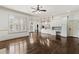 Open-concept living room connects to kitchen, featuring hardwood floors and natural light at 3908 Chaumont Dr, Apex, NC 27539