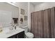 Bathroom featuring a vanity sink, toilet, framed art, and patterned shower curtain at 4612 Hanging Fern Ln, Raleigh, NC 27604