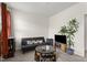A bonus room featuring a black futon, decorated tables, and a television at 4612 Hanging Fern Ln, Raleigh, NC 27604