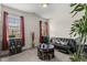 A bonus room featuring a black futon, decorated tables, and window views at 4612 Hanging Fern Ln, Raleigh, NC 27604