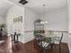 A dining room featuring a glass top table with seating for four and dark hardwood floors at 4612 Hanging Fern Ln, Raleigh, NC 27604