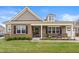 Charming home with a brick facade, covered porch, manicured lawn, and neatly trimmed shrubs at 4612 Hanging Fern Ln, Raleigh, NC 27604