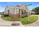 Attractive home featuring a covered porch, brick accents, and well-manicured landscaping on a corner lot at 4612 Hanging Fern Ln, Raleigh, NC 27604