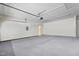 Empty garage featuring concrete floor, white walls, and a garage door at 4612 Hanging Fern Ln, Raleigh, NC 27604