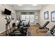 Home gym featuring exercise bikes, a treadmill, and weightlifting equipment at 4612 Hanging Fern Ln, Raleigh, NC 27604