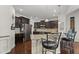 A kitchen with dark cabinets, stainless steel appliances, and a granite countertop island with bar stool seating at 4612 Hanging Fern Ln, Raleigh, NC 27604