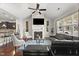 Stylish living room featuring a fireplace, dark leather furniture, vaulted ceiling, and hardwood floors at 4612 Hanging Fern Ln, Raleigh, NC 27604