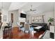 Inviting living room with a fireplace, dark leather furniture, hardwood floors, and large windows at 4612 Hanging Fern Ln, Raleigh, NC 27604