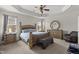 Spacious main bedroom with tray ceiling, ceiling fan, and furniture at 4612 Hanging Fern Ln, Raleigh, NC 27604