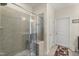 Tiled shower with glass door, a built-in bench, and decorative tile at 4612 Hanging Fern Ln, Raleigh, NC 27604