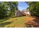 Beautiful backyard featuring a deck, lawn, mature trees, offering an ideal setting for outdoor relaxation and entertainment at 504 Belmont Cir, Wake Forest, NC 27587