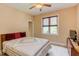 Comfortable bedroom with a cozy quilt, a window with wooden blinds and ceiling fan for air circulation at 504 Belmont Cir, Wake Forest, NC 27587