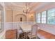 The formal dining room boasts elegant wainscoting, a tray ceiling, and classic chandelier at 504 Belmont Cir, Wake Forest, NC 27587