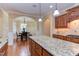 Kitchen island in foreground, with dining area featuring seating for six in the background at 504 Belmont Cir, Wake Forest, NC 27587